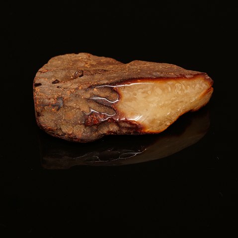A large piece of Amber, milk white. Size: 
13x10x3,5cm. W: 217