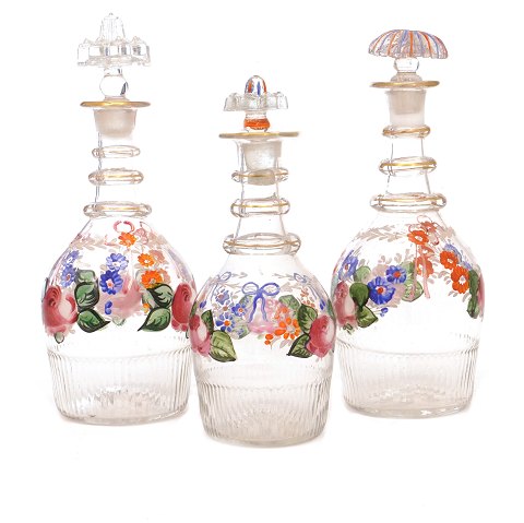 Set of three enamel decorated carafes circa 1860-80. H: 19-23cm