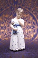 K&Co. presents: 
Royal 
Copenhagen 
porcelain 
figurine of a 
little girl 
with a doll on 
her arm...