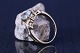 Antik Huset 
presents: 
Ladies' 
ring 14 carat 
gold, with 
inlaid light 
blue 
aquamarines. 
Stamped DIA. 
Ring size 56.