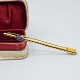 Brooch in 14k gold set with a sapphire