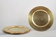 Set of five brass charger plates.